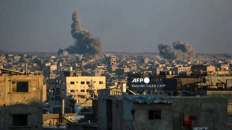 This picture taken from western Jabalia in the central Gaza Strip shows smoke billowing east of Gaza City, in the central Gaza Strip following Israeli strikes on July 13, 2025. Delegations from Israel and the Palestinian militant Hamas group have now spent a week trying to agree on a temporary truce to halt 21 months of devastating fighting in the Gaza Strip. - AFP