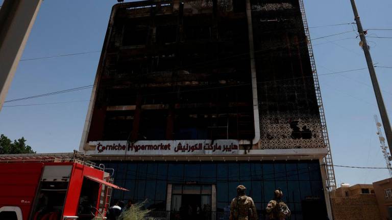 A fire truck stands next to the wreckage of a five-storey shopping center, after a massive overnight fire killed dozens of people, in al-Kut, Wasit province, Iraq, July 17, 2025. - REUTERS/Ahmed Saad