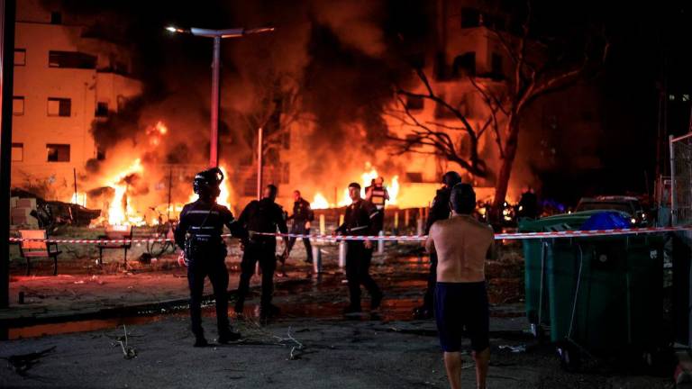 Firefighters and rescue personnel work at an impact site following missile attack from Iran on Israel, in Tel Aviv, Israel June 16, 2025. REUTERSpix