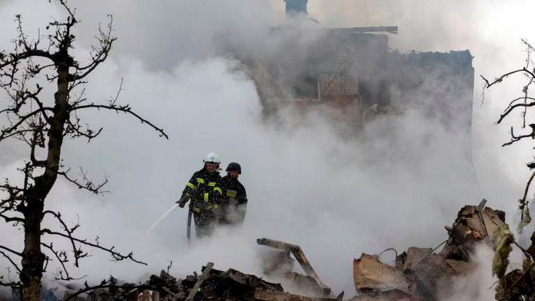 Emergency workers extinguish fire in the debris of a private house that was destroyed in a Russian rocket strike, amid Russia’s attack on Ukraine, in Markhalivka, Kyiv region, Ukraine, May 25, 2025. REUTERS/Thomas Peter/File Photo