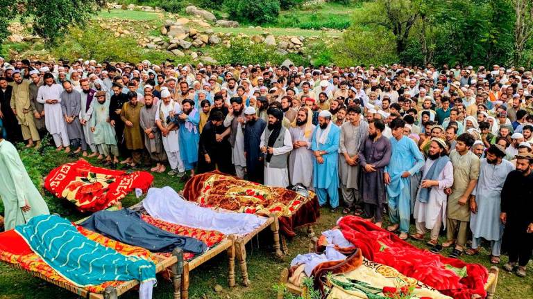Mourners and locals offer funeral prayers for victims who died in incidents related to flash floods and monsoon rains in Salarzai Tehsil of Pakistan’s Bajaur district on August 15, 2025. Heavy monsoon rains triggered landslides and flash floods across northern Pakistan, killing at least 50 people in the last 24 hours, disaster authorities said August 15. Photo by AFP
