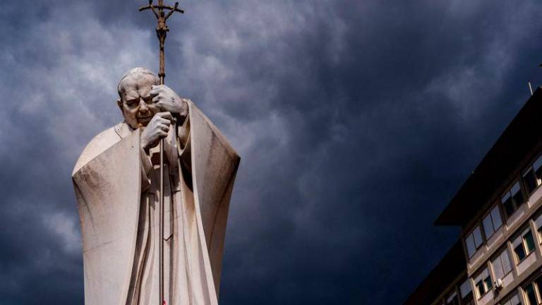 Dark clouds are seen above the statue of John Paul II outside the Gemelli hospital where Pope Francis is hospitalized with pneumonia, in Rome - AFPpix