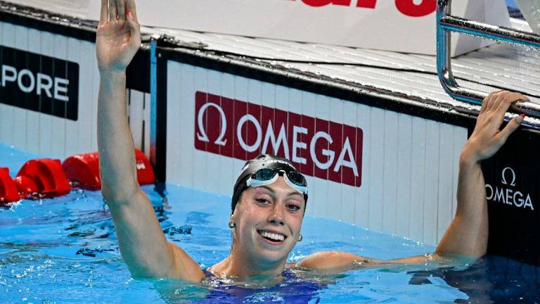 US' swimmer Gretchen Walsh celebrates after winning the final of the women's 100m butterfly swimming event during the 2025 World Aquatics Championships in Singapore on July 28, 2025. - Oli SCARFF / AFP