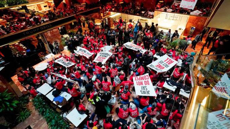 Demostrators from the human rights organiztaion Jewish Voice for Peace holds a civil disobedience action inside Trump Tower in New York on March 13, 2025. - AFPPIX