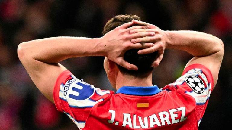 Atletico Madrid's Argentine forward #19 Julian Alvarez reacts during the UEFA Champions League Round of 16 second leg football match between Club Atletico de Madrid and Real Madrid CF at the Metropolitano stadium in Madrid on March 12, 2025. - AFPPIX