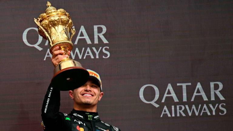 McLaren’s British driver Lando Norris lifts the first place trophy after winning the Formula One British Grand Prix at the Silverstone motor racing circuit in Silverstone, central England, on July 6, 2025-AFP