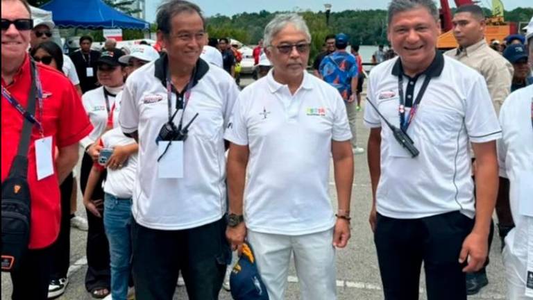 Pahang ruler Al-Sultan Abdullah Ri’ayatuddin with Theseira (right) before the start of the Royal Pahang F3000 Championship. - Pix credit: Platinum Charters Sdn Bhd