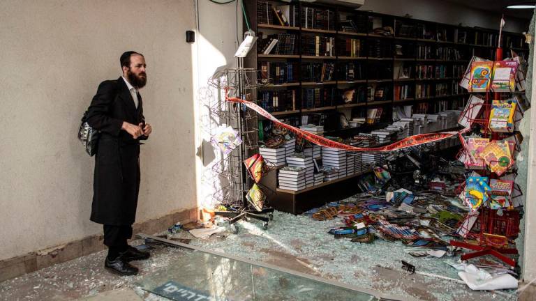 An Ultra-Orthodox Jewish man inspects the damage inside a book store at the site of an Iranian missile strike in Bnei Brak, east of Tel Aviv, on June 16, 2025. Iran unleashed a barrage of missile strikes on Israeli cities early on June 16, after Israel struck military targets deep inside Iran, with both sides threatening further devastation. AFPpix