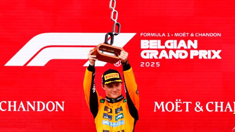 Winner McLaren’s Australian driver Oscar Piastri lifts the first place trophy after winning the Formula One Belgian Grand Prix at the Spa-Francorchamps circuit in Spa, on July 27, 2025 - Photo by SIMON WOHLFAHRT / AFP