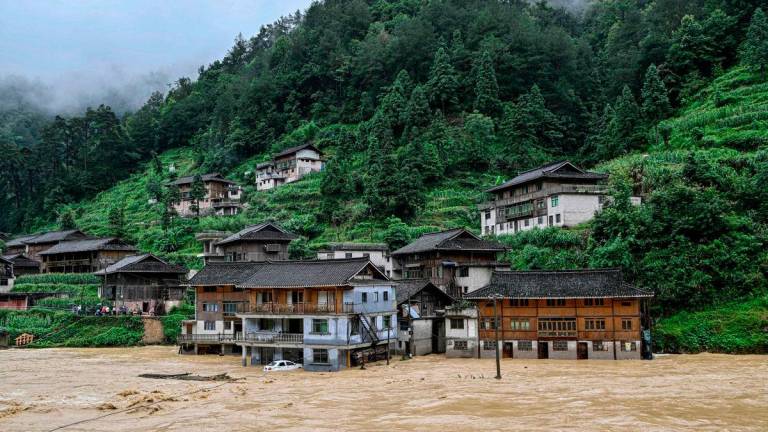 Submerged buildings at a flood-affected village in Kaili, in southwestern China’s Guizhou province on June 28, 2025. (Photo by AFP)