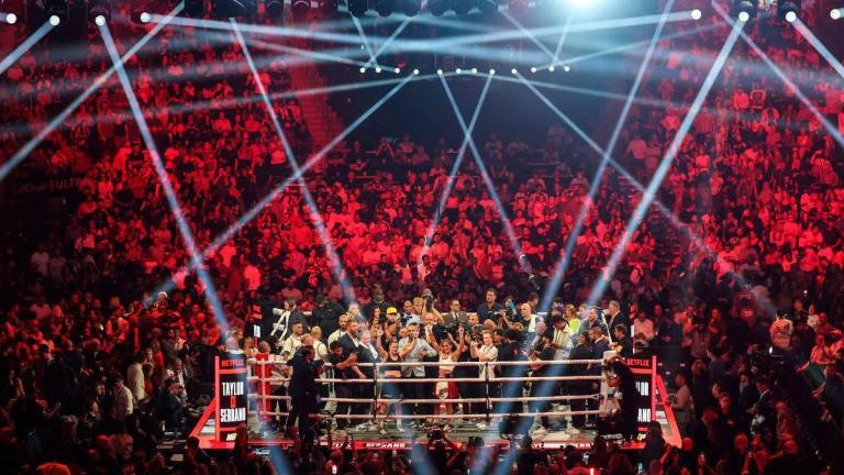 Amanda Serrano (right) and Katie Taylor (left) gesture to fans after their undisputed super lightweight championship boxing bout at Madison Square Garden. Credit: Vincent Carchietta-Imagn Images - REUTERS