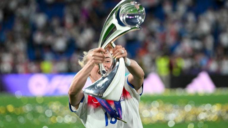 England's forward #18 Chloe Kelly lifts the trophy as she celebrates England winning the UEFA Women's Euro 2025 final football match between England and Spain at the St. Jakob-Park Stadium in Basel, on July 27, 2025. - AFPPIX