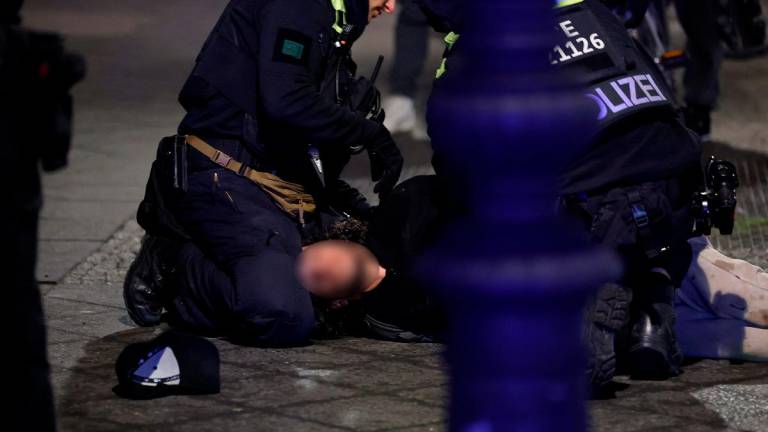 (FILES) Police apprehend a suspect at the scene where a person was stabbed near the Memorial to the Murdered Jews of Europe in Berlin on February 21, 2025. - Odd ANDERSEN / AFP