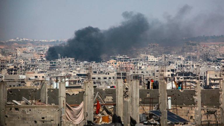A fire erupts in a residential area following Israeli bombradment in Beit Lahia on June 18, 2025. - Bashar TALEB / AFP