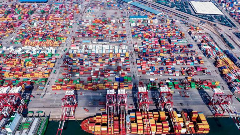 This picture shows an aerial view of shipping containers stacked at a port in Qingdao, in eastern China’s Shandong province on September 4, 2025. China OUT