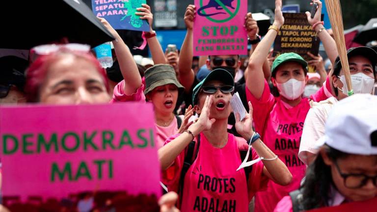 Women, including ones holding brooms and placards, shout slogans during a protest against lawmakers' perks and police brutality, brandishing brooms as a symbol of their calls for reform, outside the Indonesian parliament building in Jakarta, Indonesia, September 3, 2025. - REUTERSPIX