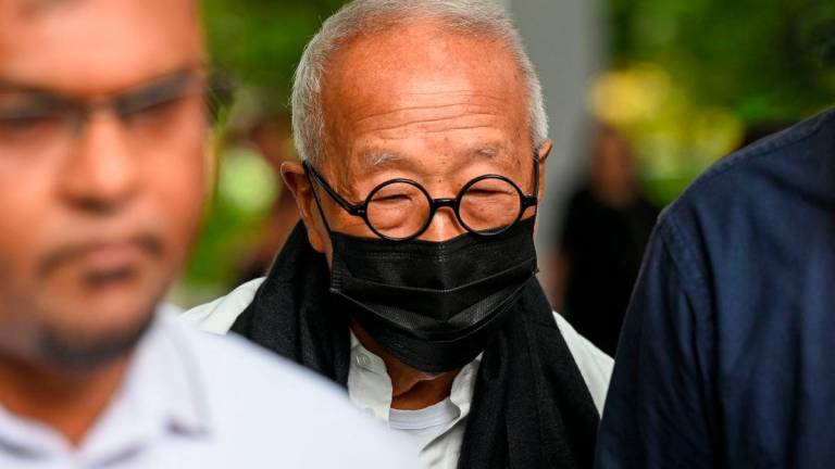 Malaysian hotel tycoon Ong Beng Seng (C) leaves the State Court in Singapore - AFP