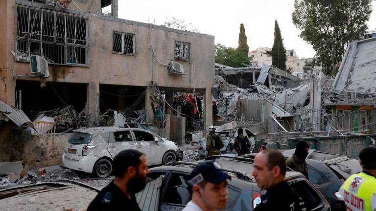 Rescuers work near a damaged building following a strike by an Iranian missile in the Israeli city of Bnei Brak, east of Tel Aviv, on June 16, 2025. Israel's military warned on June 16 of a new missile salvo incoming from Iran, as AFP journalists reported loud explosions in Jerusalem and fires outside the coastal city of Haifa. A short while ago, the IDF identified missiles launched from Iran toward the territory of the State of Israel, the army posted on Telegram, using the acronym for its official name. - Jalaa MAREY / AFP