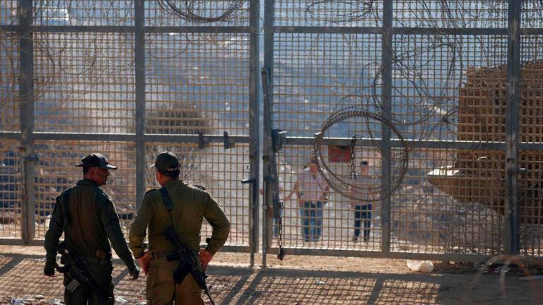 Pix for visual purposes - Israeli troops stand guard as members of Syria’s Druze community cross walk towards the fence to cross into the Israeli-annexed Golan Heights - AFPPix