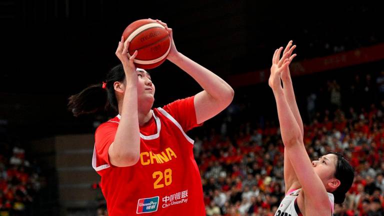 China’s Zhang Ziyu (#28) shoots as Japan’s Azusa Asahina (#14/R) tries to block during a warm-up game ahead of the FIBA Women’s Asia Cup in Xian, China’s central Shaanxi province on June 18, 2025. (Photo by AFP)