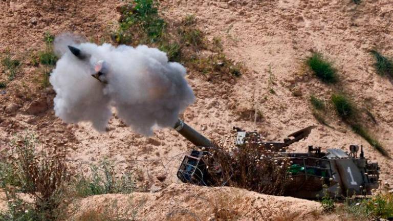 A mobile artillery unit fires towards Gaza, as seen from the Israel, May 6, 2025. REUTERSpix