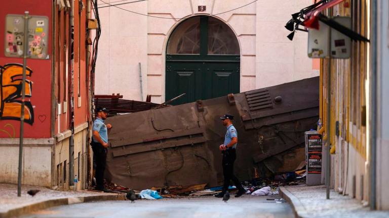 Police officers stand near the site of the accident after Gloria funicular railway car, a popular tourist attraction, derailed and crashed, resulting in multiple casualties, according to authorities, in Lisbon, Portugal, September 4, 2025. REUTERS/Pedro Nunes