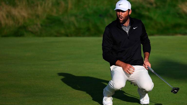 US golfer Scottie Scheffler reacts to a missed putt on the 17th green on day three of the 153rd Open Championship at Royal Portrush golf club in Northern Ireland on July 19, 2025. - HENRY NICHOLLS / AFP