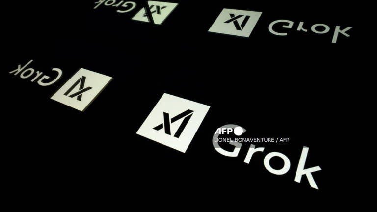 This photo illustration shows screens displaying the logo of Grok, a generative artificial intelligence chatbot developed by US artificial intelligence company xAI, in Toulouse, southern France, on January 15, 2025. - AFP