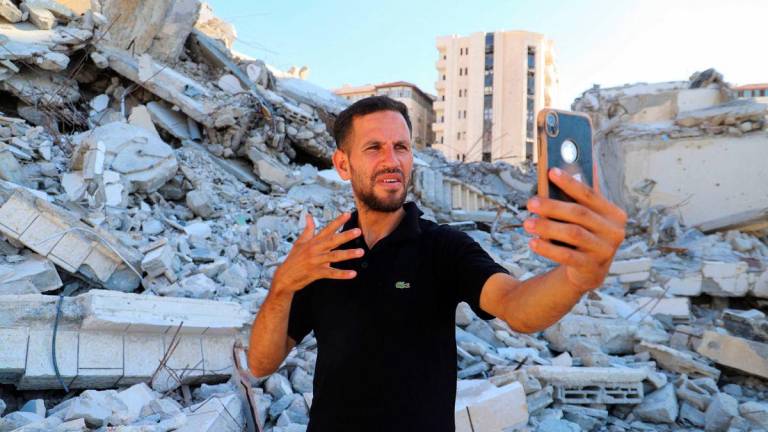 Hearing-impaired Palestinian influencer Basem Al-Habel, who turned to social media to document the war in Gaza through sign language, reaching a wide range of followers from both inside and outside of the enclave, films himself in Gaza City, August 5, 2025. Ebrahim Hajjaj/ REUTERS