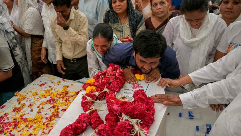 Relatives mourn near the coffins of victims, who were killed in the Air India flight crash, during a special prayer before a funeral ceremony in Ahmedabad on June 15, 2025. AFPpix