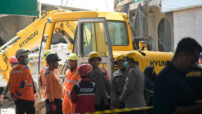 Rescuers search for survivors at Al Khoziny Islamic boarding school in Sidoarjo, East Java province on October 1, 2025, after the multi-storey school building collapsed two days earlier. - Juni KRISWANTO / AFP