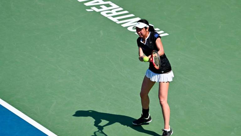 Aoi Ito of Japan plays a backhand against Jasmine Paolini of Italy during their second round match on Day Three of the WTA 1000 National Bank Open at IGA Stadium on July 29, 2025 in Montreal, Quebec, Canada. - AFPPIX