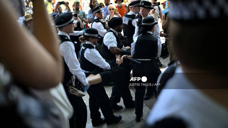 A protester is carried away after being arrested as people gather in support of the pro-palestinian group “Palestine Action”, in Parliament Square, London on July 12, 2025, following the Home Secretary’s decision to proscribe the group under anti-terror laws. - AFP