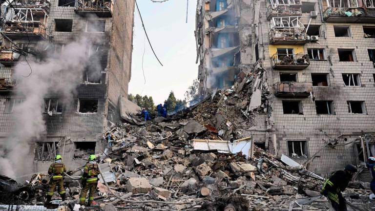 Ukrainian rescuers conduct a search and rescue work in a heavily damaged residential building following the Russian missile strike in Kyiv on June 17, 2025, amid the Russian invasion of Ukraine. Russian airstrikes on Ukraine’s capital Kyiv early on June 17, killed at least one person, a US citizen with 16 more injured, the city’s mayor said. - Genya SAVILOV / AFP
