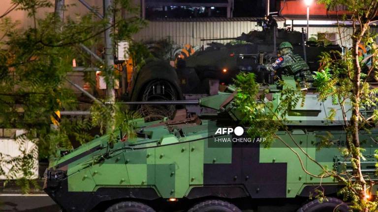 Soldiers riding a CM-34 Clouded Leopard, officially Taiwan Infantry Fighting Vehicle (TIFV), take part in the annual Han Kuang military exercises in Taipei on July 15, 2025. - I-Hwa Cheng / AFP