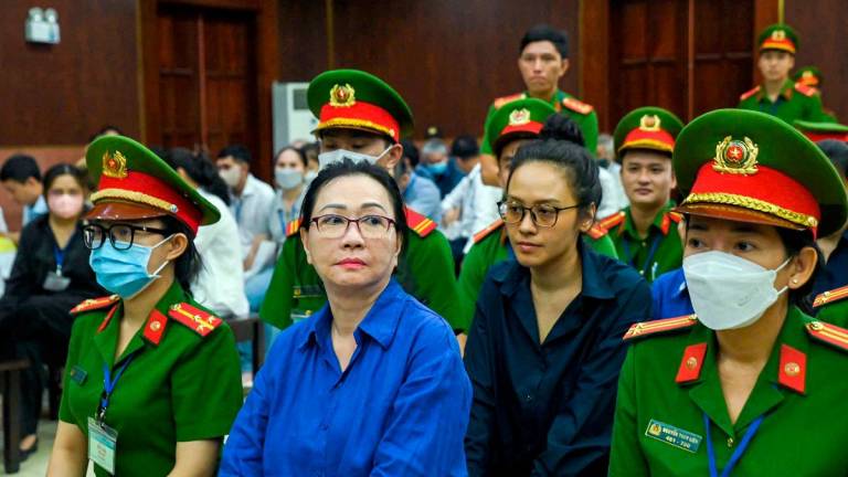 (FILES) Vietnamese property tycoon Truong My Lan (C-L) looks on at a court in Ho Chi Minh city on March 25, 2025. - AFPpix