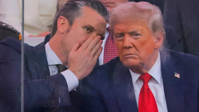 U.S. Secretary of Defense Pete Hegseth talks to U.S. President Donald Trump during the U.S. Army’s 250th Birthday parade, on the same day of U.S. President Donald Trump 79th birthday, in Washington, D.C., U.S., June 14, 2025. - REUTERS/Carlos Barria/File Photo