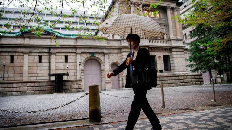 For visual purposes only - A person walks in front of the bank of Japan building in Tokyo, Japan, April 7, 2023. REUTERSpix
