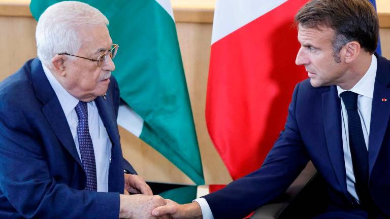 French President Emmanuel Macron (R) shakes hands with Palestinian President Mahmud Abbas during a meeting on the sidelines of the 79th Session of the United Nations General Assembly in New York on September 25, 2024. - AFPPix