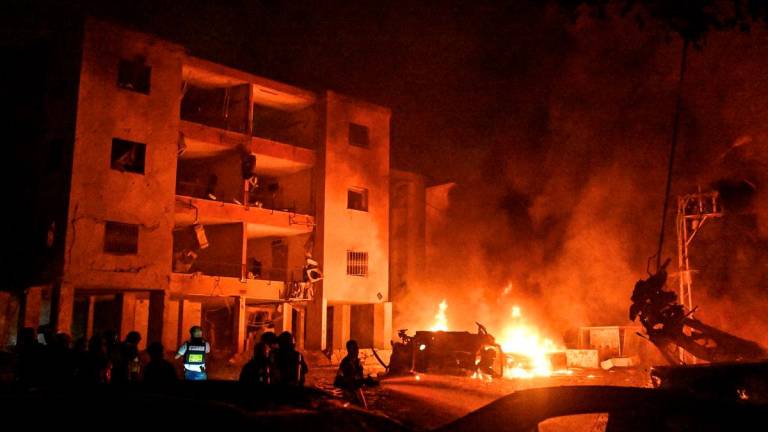 Firefighters and rescue personnel work at an impact site following missile attack from Iran on Israel, in Haifa, Israel, June 15, 2025. REUTERSpix