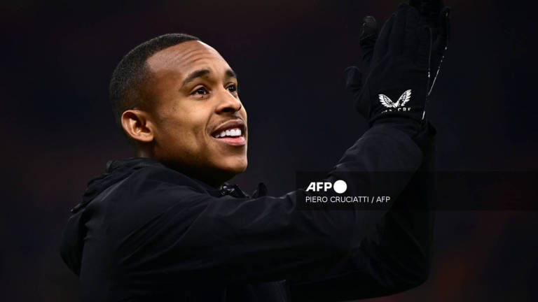 Feyenoord's Brazilian forward #14 Igor Paixao greets fans before the UEFA Champions League knockout round play-off second leg football match between AC Milan and Feyenoord at San Siro stadium in Milan, on February 18, 2025. - AFP