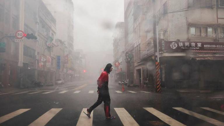 A person crosses the road as Typhoon Krathon approaches, in Kaohsiung, Taiwan. REUTERSPIX