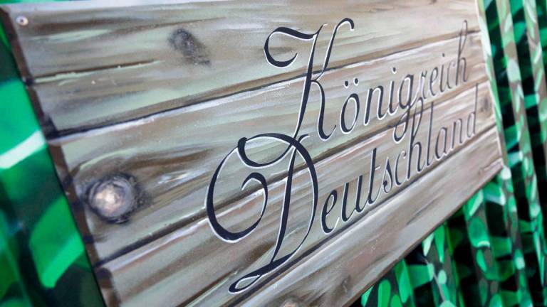 A sign of the so-called 'Kingdom of Germany' (Koenigreich Deutschland), is seen at the fence of the entrance gate, in Wittenberg, eastern Germany on October 23, 2023. - AFPPIX