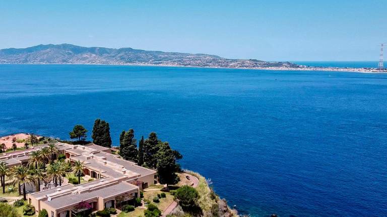 (FILES) A general aerial view shows the Sicilian coast towards Cape Torre Faro, over the Strait of Messina, taken from the outskirts of the town of Scilla, in Calabria region in southern Italy, on July 7, 2020. - Andreas SOLARO / AFP