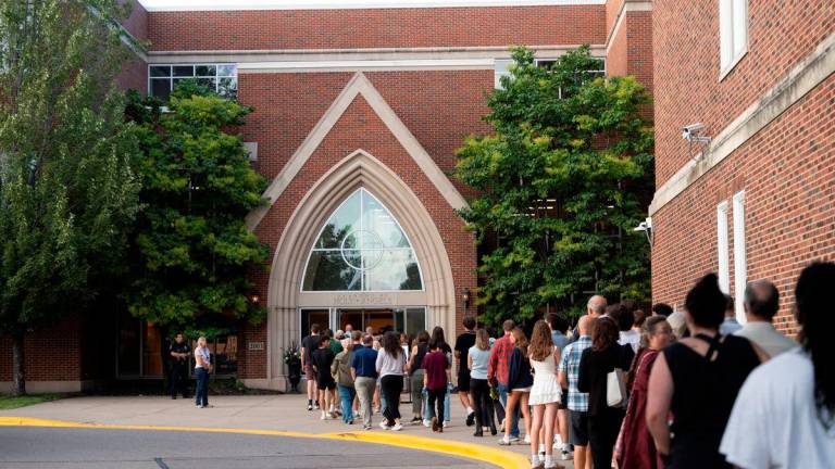 People line up to attend a prayer vigil at Academy of Holy Angels following a shooting earlier in the day at Annunciation Church in Minneapolis, in Richfield, Minnesota, U.S. August 27, 2025. REUTERS/Tim Evans