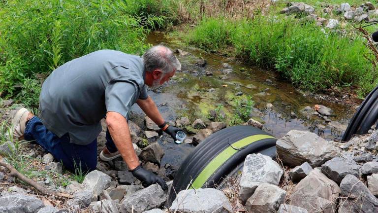 Civil engineer and water quality expert Bob Bowcock conducts a test for forever chemicals on a sample from a property in Dalton, Georgia, on June 12, 2025. - Issam AHMED / AFP