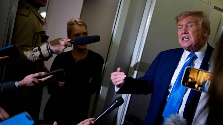 US President Donald Trump speaks to reporters about the G7 Summit aboard Air Force One while travelling back to Washington from Canada on June 16, 2025. US President Donald Trump left a G7 summit in Canada a day early on June 16, heading back to the White House as Israel and Iran traded missile fire for a fifth straight day. - Brendan Smialowski / AFP