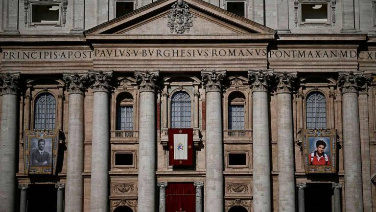 Portraits of late Pier Giorgio Frassati (L) and late Italian teenager Carlo Acutis are displayed onto the facade of Saint Peter’s Basilica ahead of a Holy Mass and canonisation of Blessed Carlo Acutis and Pier Giorgio Frassati in St Peter’s Square at the Vatican on September 7, 2025.