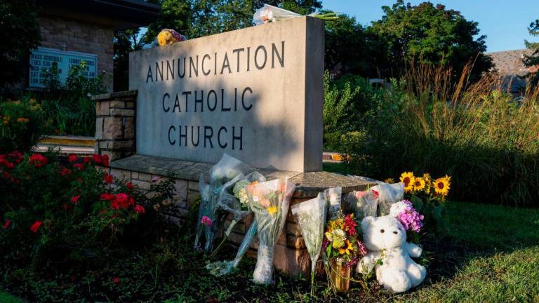Flowers and a stuffed animal sit outside the Annunciation Church, which is a home to an elementary school and was the scene of a shooting the day before, in Minneapolis, Minnesota, U.S. August 28, 2025. REUTERS/Tim Evans