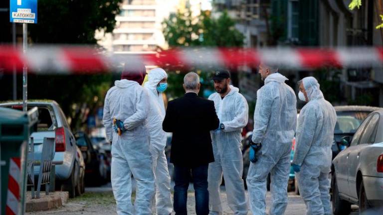 Forensics officers investigate the area of a blast caused by an explosive device outside a bank that killed a 38-year old woman, in Thessaloniki, Greece, May 3, 2025. REUTERSpix